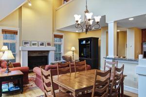 a dining room and living room with a table and chairs at Castle Hill Condo in Cavendish