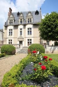 a large house with red flowers in front of it at Le Clos Renaissance in Amboise