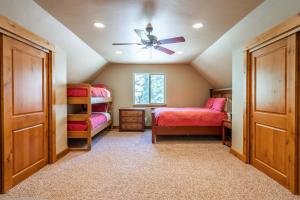 a bedroom with two bunk beds and a ceiling fan at Gallatin River Getaway in Big Sky