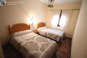 A bed or beds in a room at El Rincon de Piedra