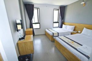 Postel nebo postele na pokoji v ubytování Summering Hotel