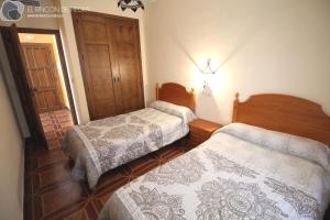 A bed or beds in a room at El Rincon de Piedra