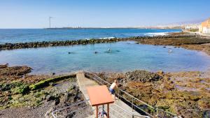a group of people in a swimming pool on the beach at NARANJA in Arinaga
