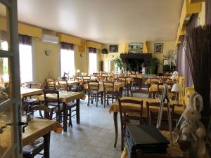 a restaurant with tables and chairs and a teddy bear at Le Provençal in Aups