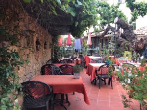 an outdoor restaurant with tables and chairs and umbrellas at Le Provençal in Aups