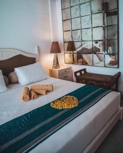 a bedroom with a bed with two towels on it at Villa Coralita Gili Trawangan in Gili Trawangan