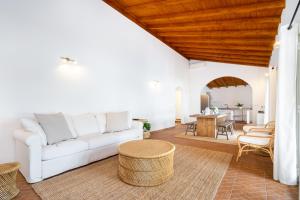 a living room with a white couch and a table at WHome | Comporta Family Beach House in Comporta