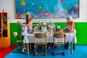 a group of children are sitting at a table in a restaurant at Amathus Beach Hotel Limassol in Limassol