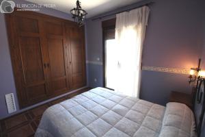 A bed or beds in a room at El Rincon de Piedra