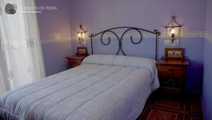A bed or beds in a room at El Rincon de Piedra