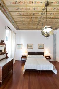 a bedroom with a bed and a wooden ceiling at Hotel Miranda in Hydra