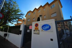 a sign on a fence next to a building at El Castell Orange Costa in Alcossebre