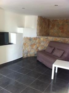 a living room with a couch and a table at Gîte Polema in Marseille