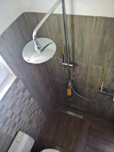 a bathroom with a shower with a toilet and a lamp at sunflower in Budapest