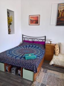a bedroom with a bed with a blue comforter at sunflower in Budapest