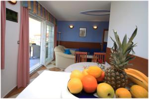 a living room with a table with fruit on it at Apartmani- Šjor -Primošten-Apartmani- has 2 large apartments and 2 smaller ones -Primošten Lokvice 6 in Primošten +42 photos