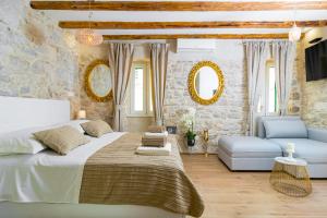 a bedroom with a large bed and a couch at LUX AURELIUS in Split Centre Old Town in Split