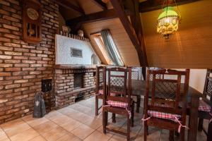 a dining room with a table and a brick fireplace at Ferienwohnung Flämisches Weinhaus in Wintrich