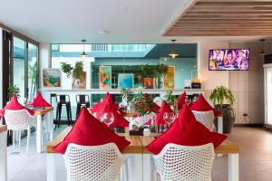 un restaurante con una mesa con servilletas rojas. en Oceanstone by Holy Cow, 2-BR, 90 m2, pool view en Bang Tao Beach