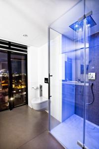 a bathroom with a glass shower and a toilet at COOL MAMA Hotel Salzburg in Salzburg +41 photos