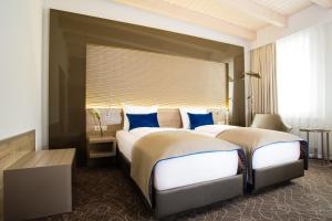 Postel nebo postele na pokoji v ubytování Hotel Atlas Leipzig