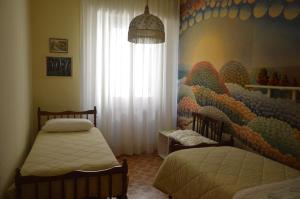 A bed or beds in a room at Appartamento in paese