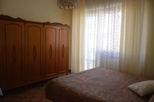 A bed or beds in a room at Appartamento in paese