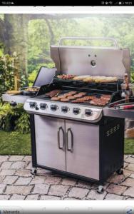 a grill with some food on top of it at LANELU apartman in Rogoznica