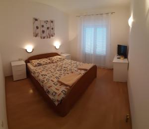 Postel nebo postele na pokoji v ubytování Apartmani Matušan