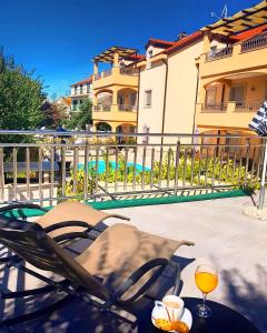 a patio with a chair and a glass of wine at Villa Ljubica in Vodice