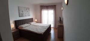 Postel nebo postele na pokoji v ubytování Apartmani Matušan