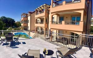 a building with a patio with chairs and a pool at Villa Ljubica in Vodice