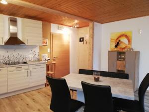 a kitchen with a table and chairs in a room at Simonbauerhof in Bad Kleinkirchheim