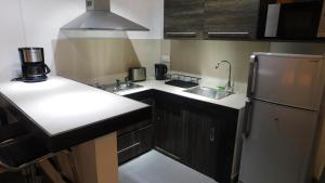 a small kitchen with a sink and a refrigerator at Arkenstone Studios in La Gaulette