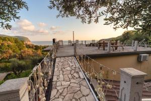a walkway with a view of the ocean on a hill at Apartments Mirian in Petrovac na Moru