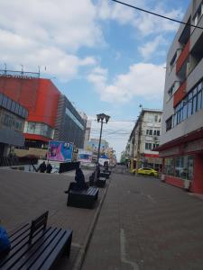 a group of benches on a city street with buildings at Apartament Flo in Constanţa