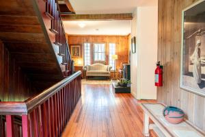 a hallway with wood floors and a stairway at Black Mountain Inn in Black Mountain