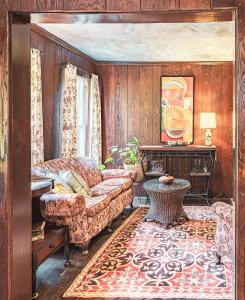 a living room with a couch and a table at Black Mountain Inn in Black Mountain