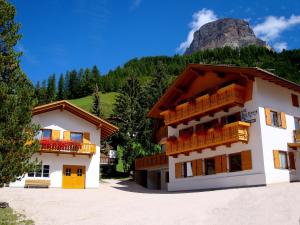 a building with a mountain in the background at La Pineta in Colfosco