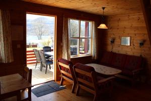 a living room with a couch and a table and a window at Camp Åpta in Farsund