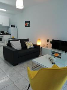 a living room with a couch and a table at Ocean Blue Apartments in Paphos City