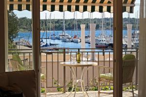 a table on a balcony with a view of a marina at VILLA V&D in Milna
