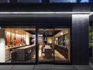 a restaurant with a bar in the middle of a building at Kyoto Gion U-BELL Hotel in Kyoto