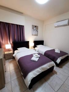 En eller flere senge i et værelse på Tony’s Boutique Apartment