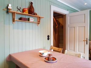 a table with a cup of coffee on top of it at Bakarstuo, Utpå Neset in Trofors