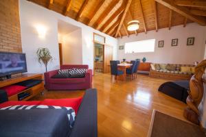 a living room with a couch and a dining room at Fishermans Cottage in Lagos in Lagos