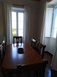a dining room table with chairs and a plate on it at La Clinica in Ballota