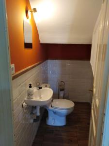 a bathroom with a toilet and a sink at La Clinica in Ballota