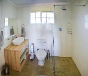 a bathroom with a toilet and a sink and a shower at Addo Park Vista in Addo