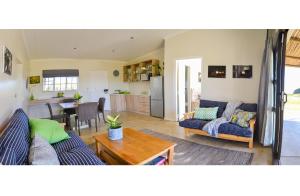 a living room with two couches and a table at Addo Park Vista in Addo